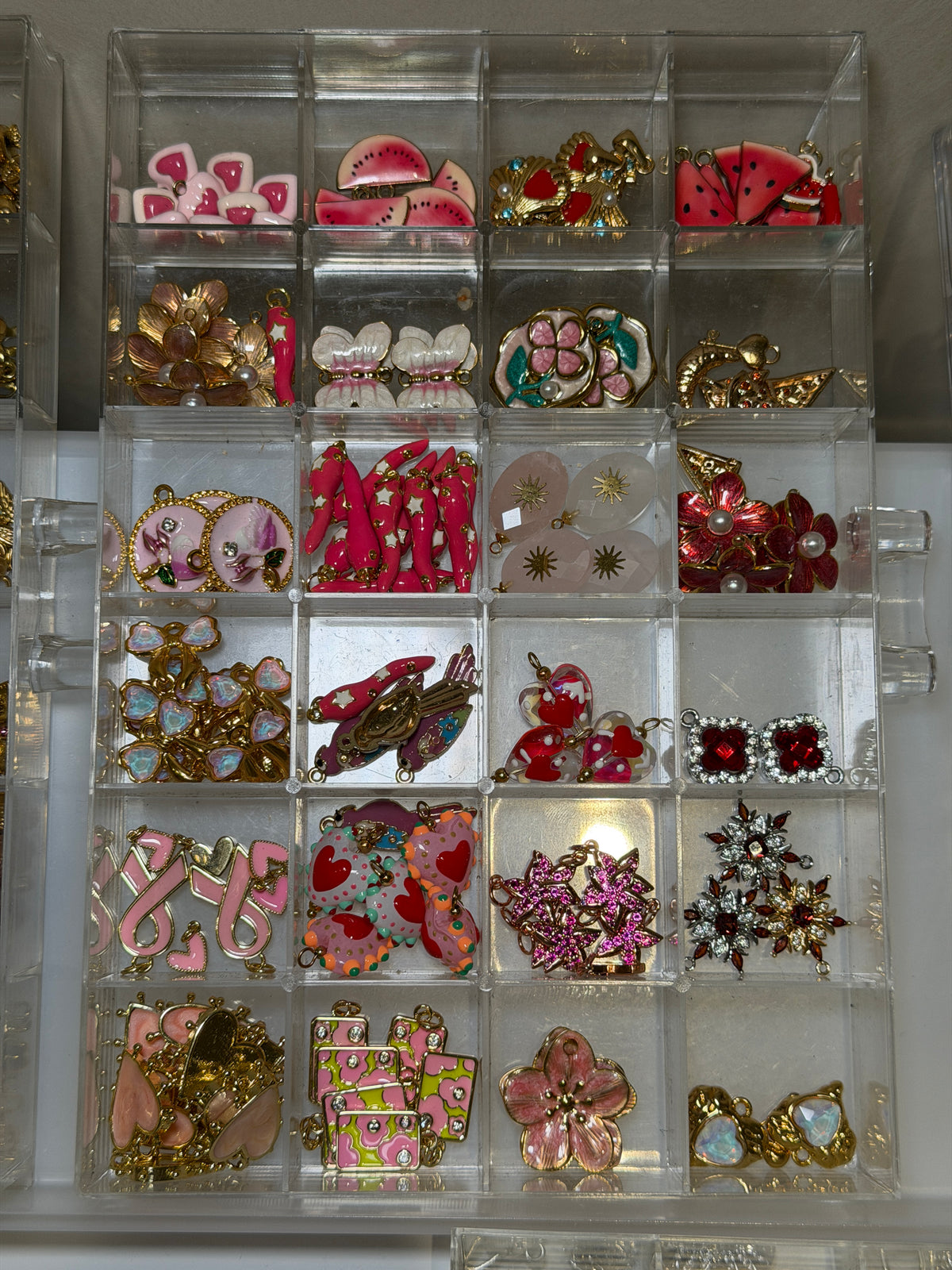 Tray of pink and red bow and heart charms