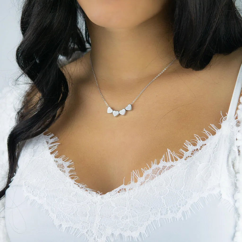 a close up of a woman wearing a necklace