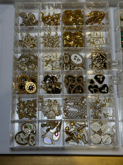 Compartment tray of gold plated charms to choose from