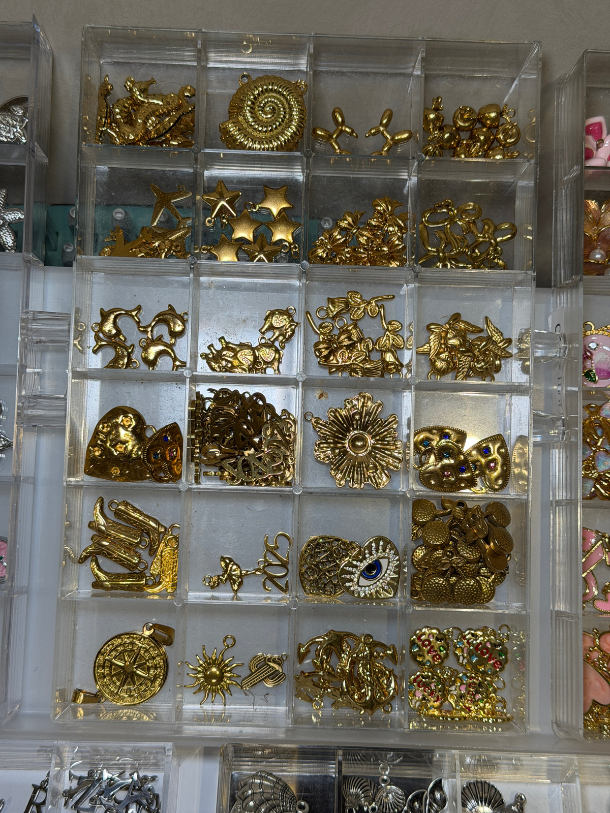 Tray of gold flower and spiral charms