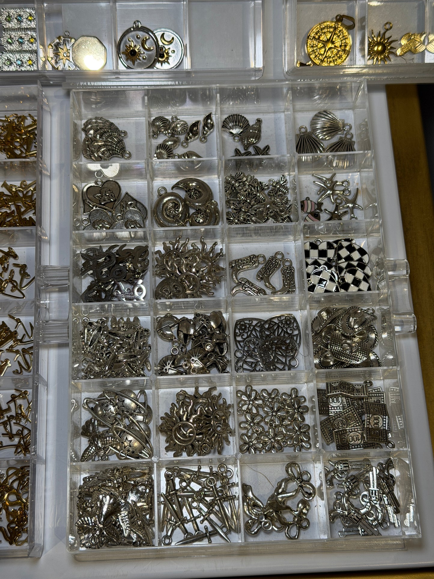 Tray of silver charms including chequered and patterned designs