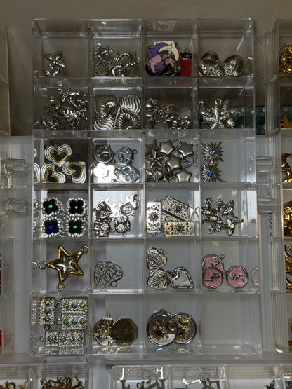 Tray of silver charms set with coloured crystals