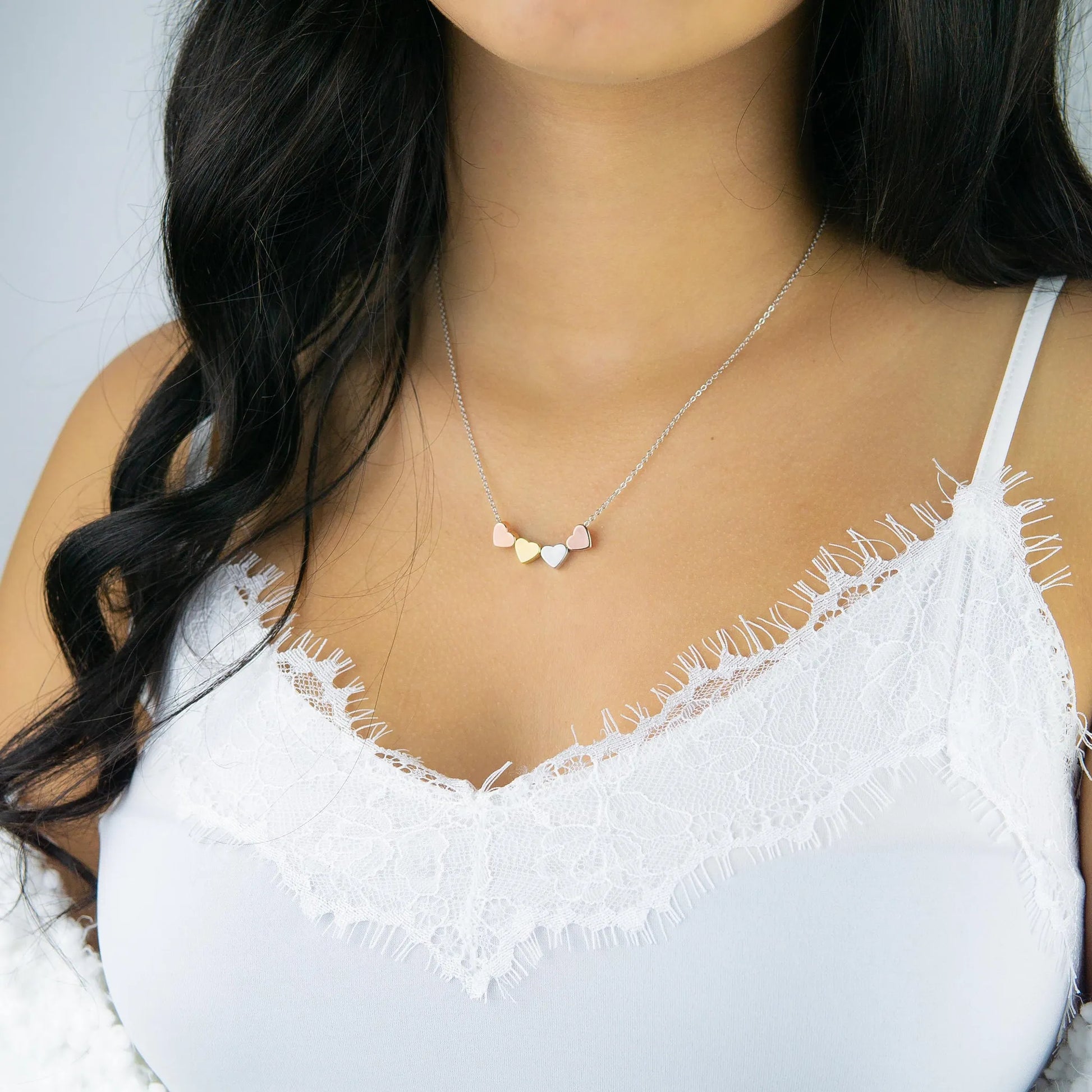 a close up of a woman wearing a white top
