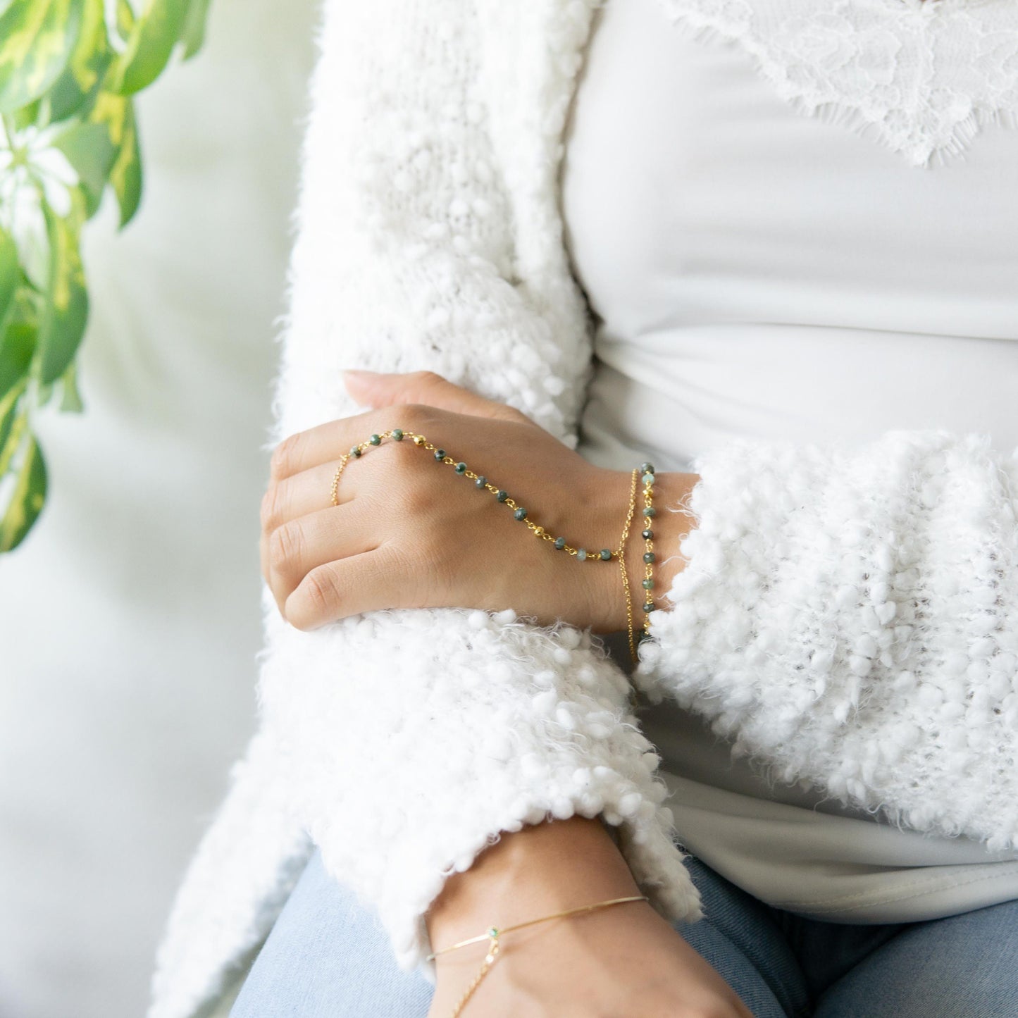 a woman wearing a white jacket and a beaded bracelet Birthstone hand chain for adventurers Explorer's gold filled jewelry