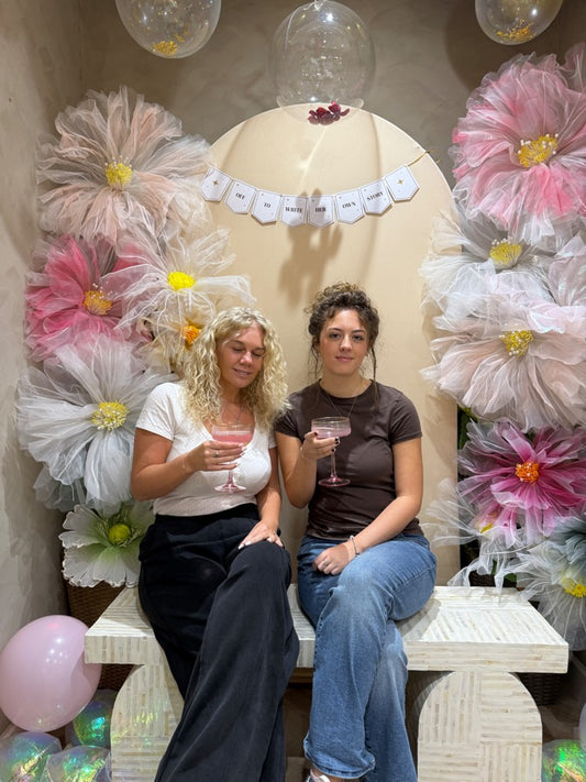 Two friends on the Bloom Bench after a permanent jewellery appointment