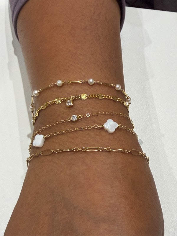 Stack of gold permanent bracelets